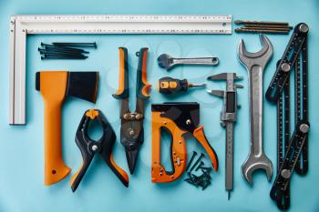 Professional workshop instrument, closeup view, blue background, nobody. Carpenter tools, builder or woodworker equipment,