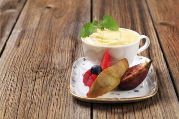 Bowl of creamy pudding and fresh fruit
