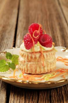 Custard filled puff pastry shell topped with raspberries