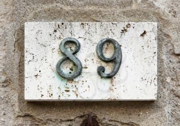 Block number on a weathered wall - detail