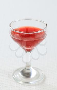 Red juice in a wine glass