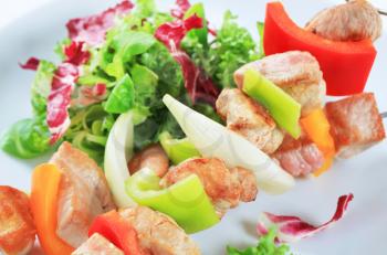 Chicken and pork skewers with green salad