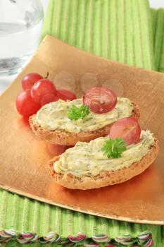 Whole grain crisp rolls with herb butter  and grapes
