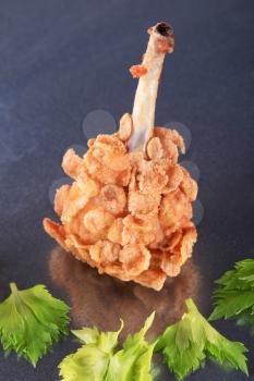Chicken drumstick coated with corn flakes - closeup