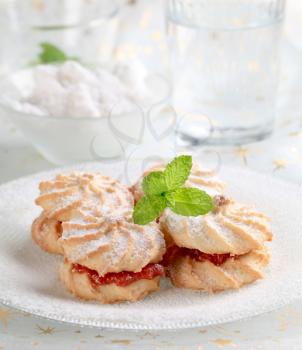 Butter cookies with jam, powdered with icing sugar 
