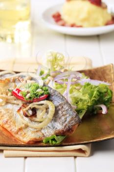 Pan-roasted trout fillet served with green salad