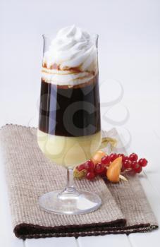 Glass of liqueur coffee with whipped cream 