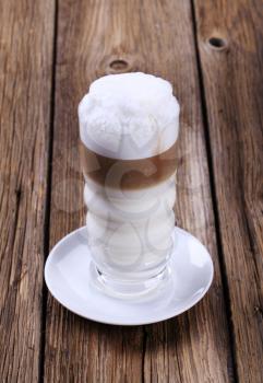 Glass of Latte macchiato with milk foam 
