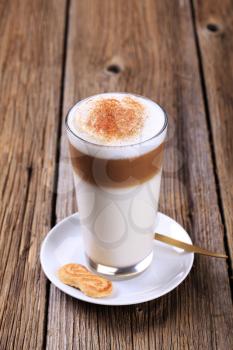 Glass of Latte macchiato with a dusting of nutmeg 
