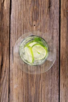 Glass of cold drink with slices of lime