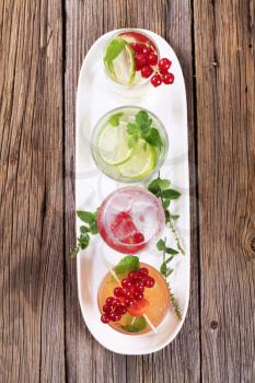 Glasses of iced drinks garnished with fresh fruit