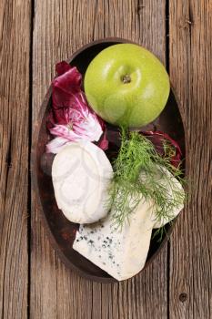 Various kinds of cheese, fresh radicchio and apple 