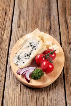 Various types of cheese on cutting board