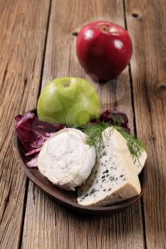 Various kinds of cheese, fresh radicchio and apple 