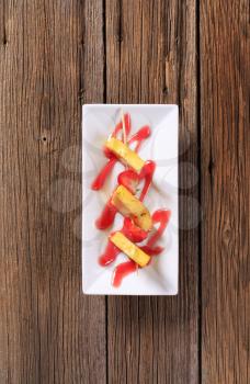 Pineapple and strawberry skewer with sweet sauce