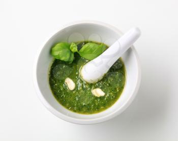 Basil pesto with crushed cashew nuts in a mortar