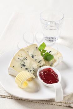 Wedges of blue cheese and  fruit preserve