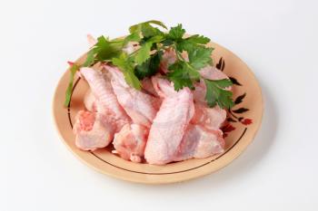 Raw chicken wings on a plate