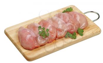Raw chicken breasts on a cutting board
