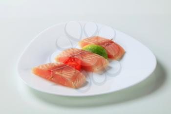 Raw fish skewer on a plate
