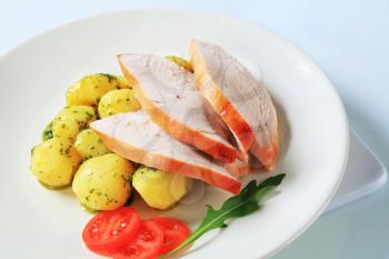 Slices of roast turkey breast and potatoes