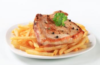 Pan seared pork chop with French fries