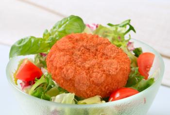 Fried breaded cheese with green salad