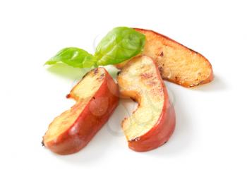 Pan fried apple slices on white background
