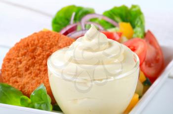 Cup of mayonnaise, fried cheese with vegetable salad 