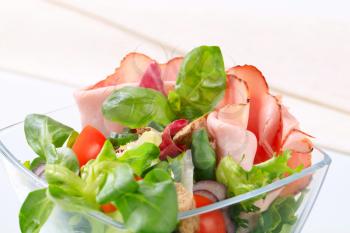 Green salad with thin slices of ham