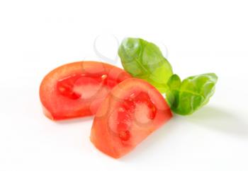 Fresh tomato wedges on white background