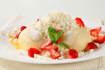 Strawberry dumplings with cottage cheese, sugar and butter