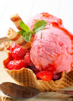 Ice cream with fresh strawberries in waffle basket