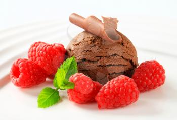 Scoop of chocolate ice cream with fresh raspberries