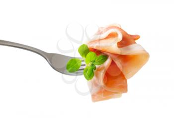 Thin slices of Prosciutto on a fork