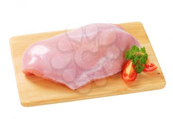 Raw skinless turkey breast  on cutting board