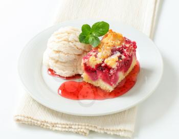 Berry fruit crumble slice with ice cream and raspberry sauce