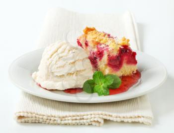 Berry fruit crumble slice with ice cream and raspberry sauce