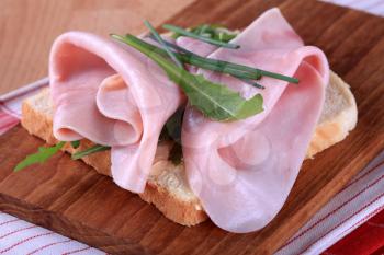 Open faced ham sandwich with greens and chives