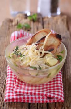 Chicken or garlic soup with grated cheese and ham