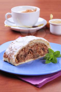 Slice of apple strudel and a cup of coffee