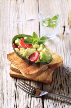 Avocado salad and toasted bread - closeup