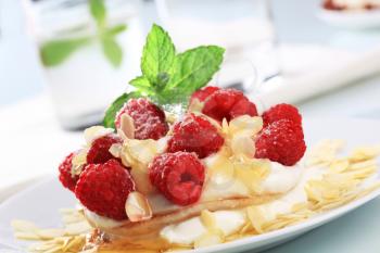 Cream pancakes with fresh raspberries