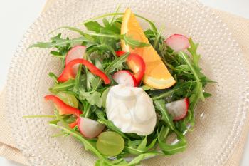 Salad greens with radish, pepper and grapes
