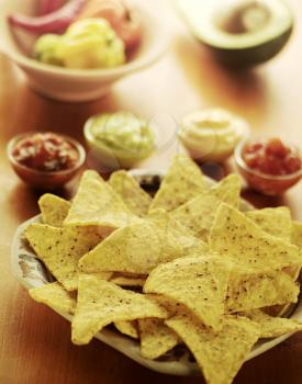 Tortilla chips and various dipping sauces
