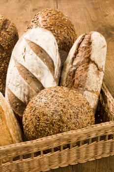 Assorted loaves of bread in a wicker basket