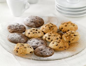 Chocolate chip cookies sprinkled with powdered sugar and cocoa
