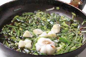 Sauteing green onion and garlic on a pan