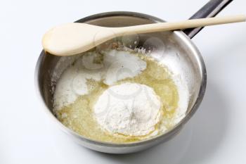 Wheat flour and heated butter in a saucepan 