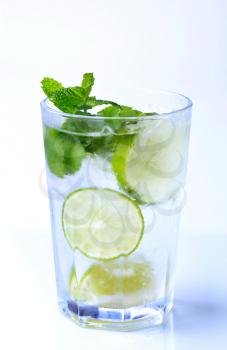 Glass of iced drink with lime and mint